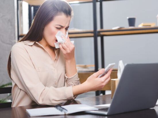 kobieta siedzi przy laptopie, katar, alergiczny nieżyt nosa
