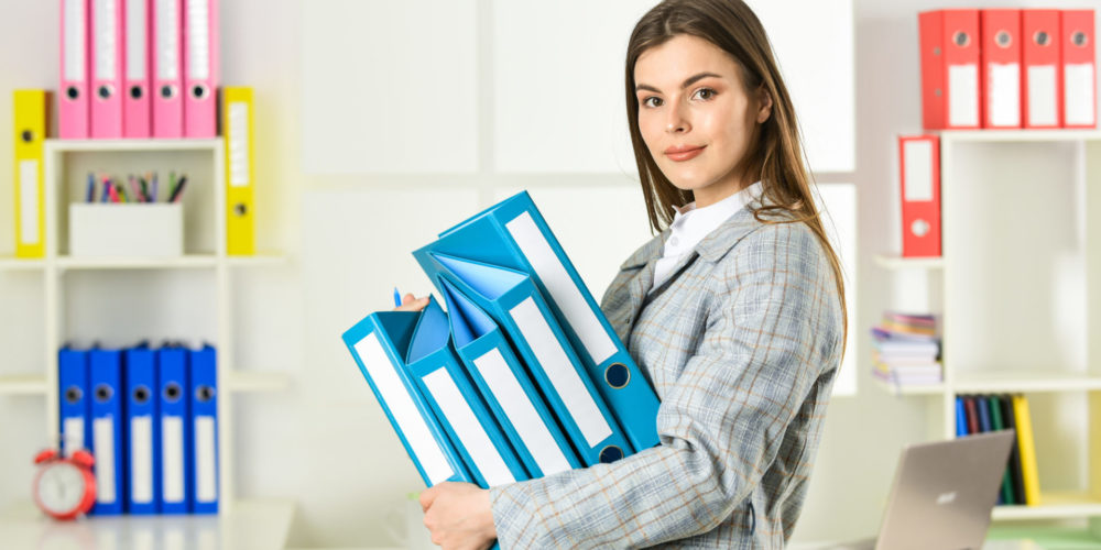 Girl businesswoman with documents. Administrator secretary. Office worker. Formal fashion. Woman hold office folder. College university student. Responsible trainee. Cute shy woman in jacket.